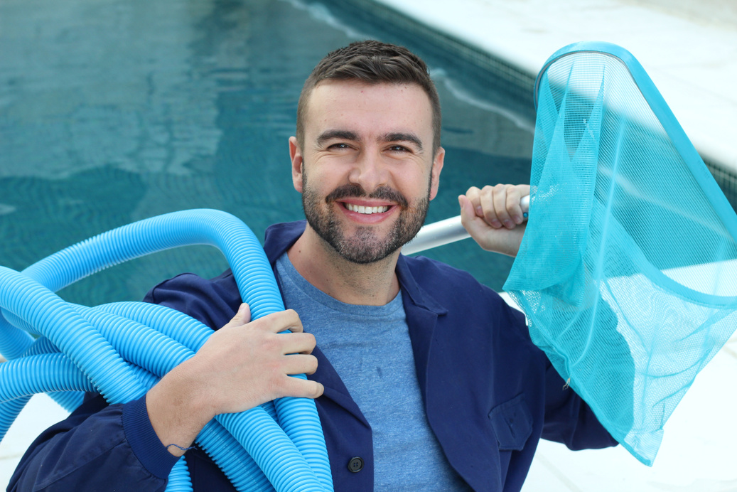 Employee of swimming pool cleaning service